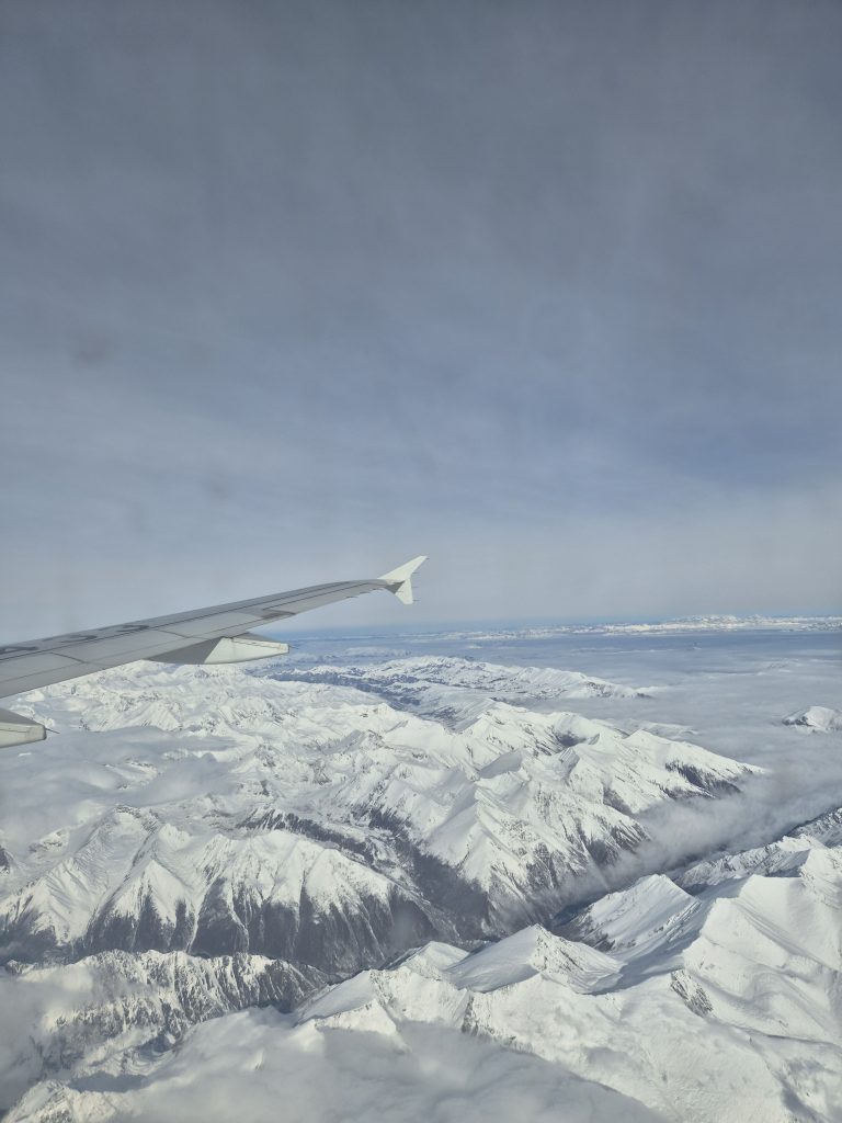 Snow-capped mountains viewed from plane window en route to Nyingchi