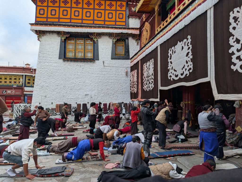 Early pilgrims performing their morning prayers at Barkhor Street around Jokhang Temple