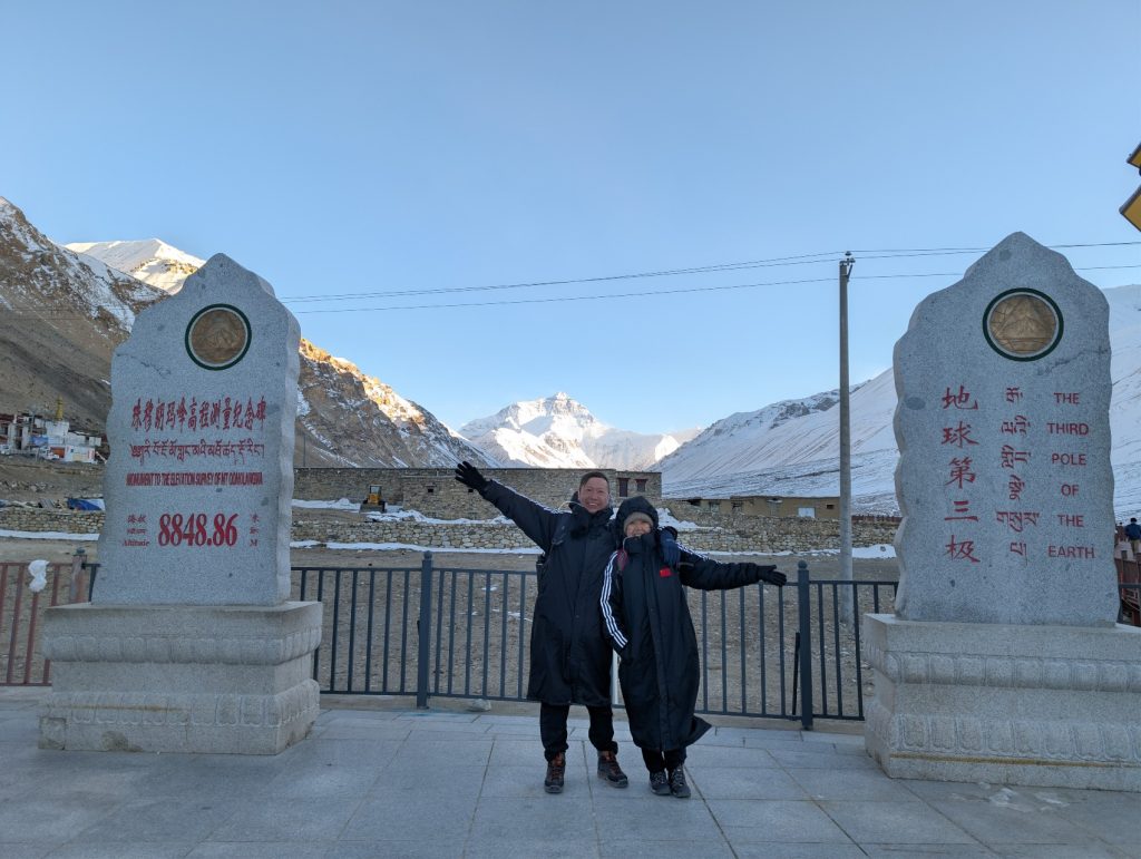 Everest Base Camp sign with Mount Everest in the background